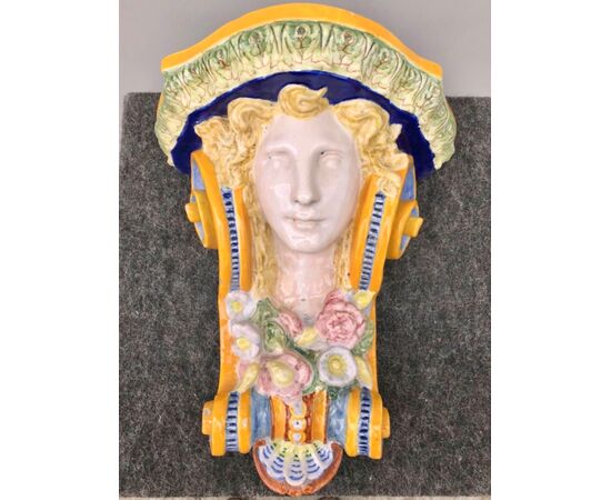 Majolica shelf with female face and art nouveau floral motifs.Minardi manufacture, Faenza.     