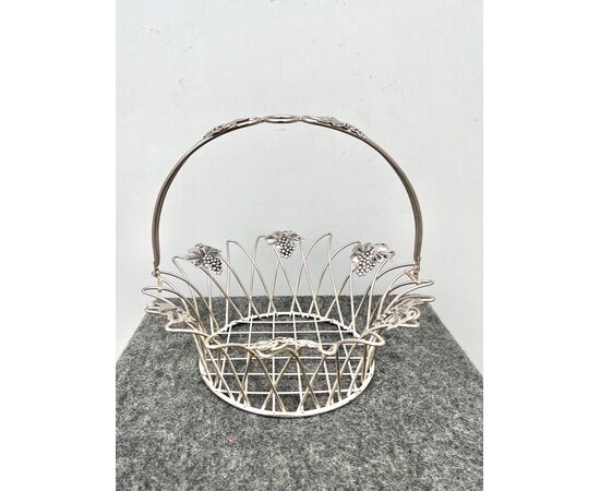 Perforated fruit basket in silver metal with vine branch motifs.     