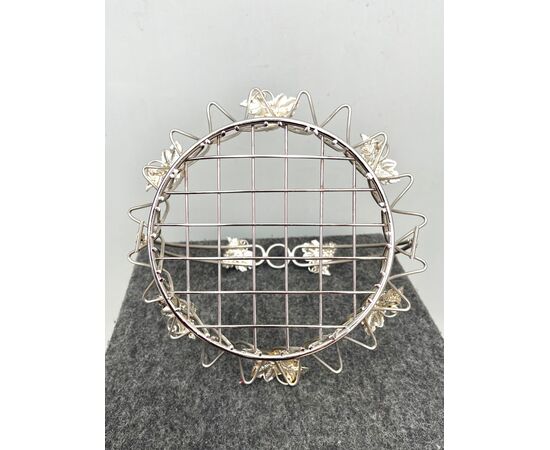Perforated fruit basket in silver metal with vine branch motifs.     