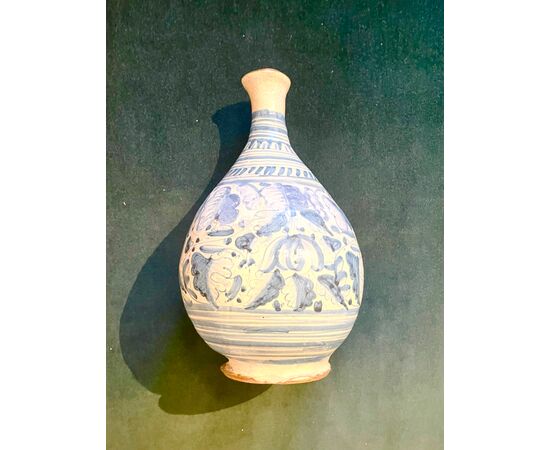 Majolica bottle with blue monochrome decoration with stylized plant motifs. Montelupo.     