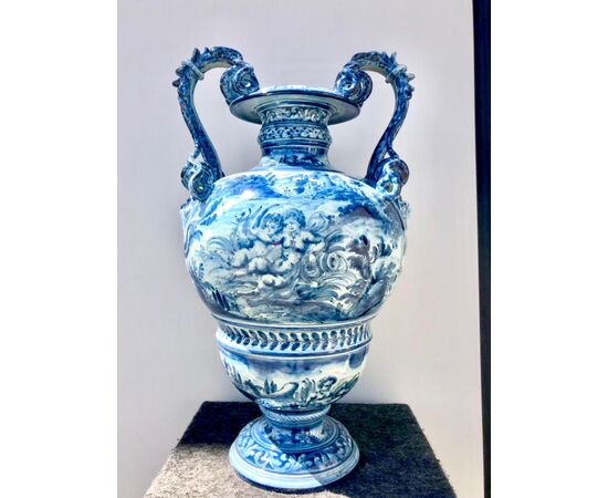 Large majolica vase in turquoise monochrome with serpentine handles and decoration with characters, cherubs and satyrs on a rural background in Savona style, Cantagalli manufacture Florence.     