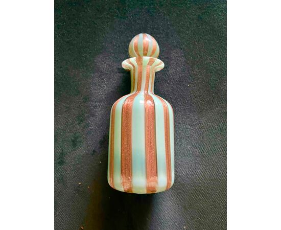Perfume bottle in glass with milky green and aventurine vertical bands.Cenedese manufacture, Murano.     