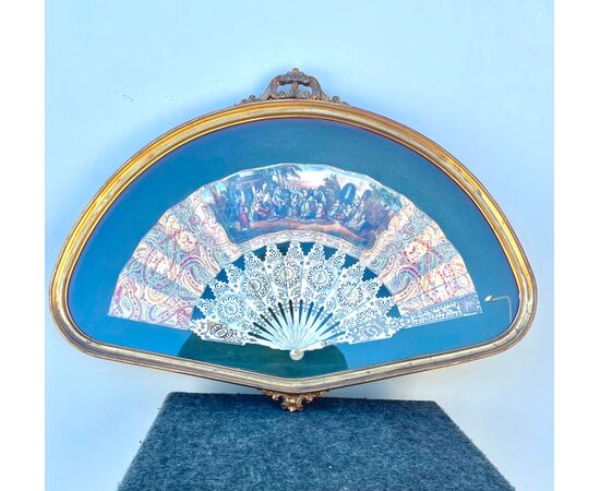 Fan framed with bunting painted with popular scene and ribs in pierced ivory.     