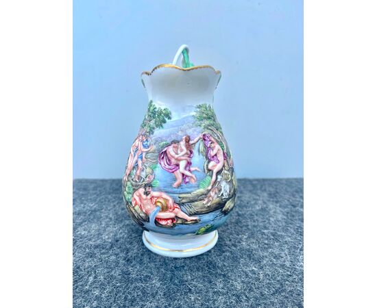 Porcelain milk jug with polychrome bas-relief decoration and interwoven vegetable motif grip.Manufactured by Doccia Ginori.     