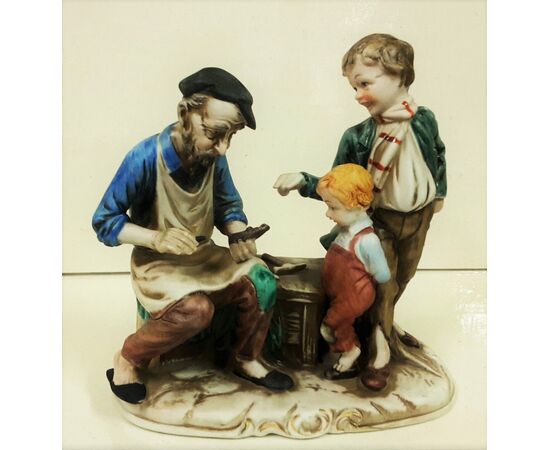 Hand painted ceramic shoemaker with children