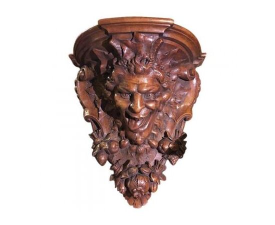 Carved walnut shelf depicting a satyr&#39;s head     