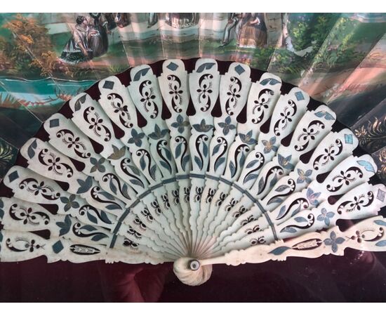 Fan in ivory pierced with pavese in painted paper with characters. Spain.     