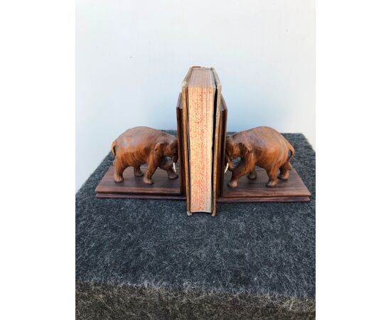 Pair of rosewood bookends depicting elephants with ivory tusks.     