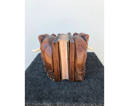Pair of teak wood bookends depicting a pair of elephants. Ivory tusks.     