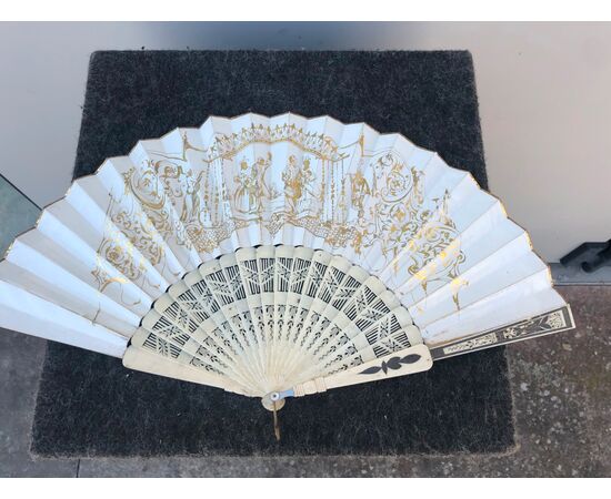 Openwork ivory fan with Pavese paper with watercolor prints with gallant and rustic scenes. France.     