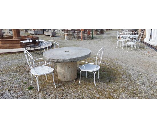 Table composed of ancient stone millstones     