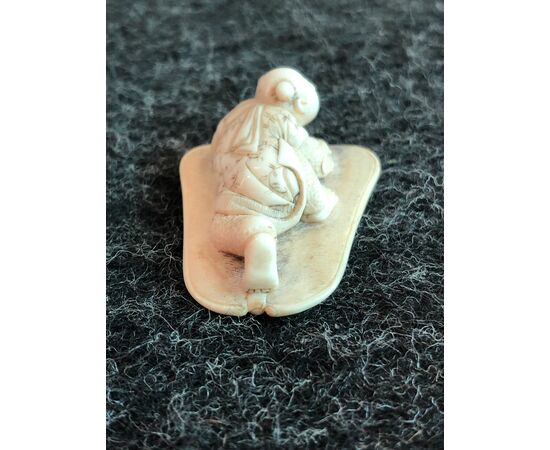 Netsuke in ivory depicting a character on a lotus leaf. Japan     