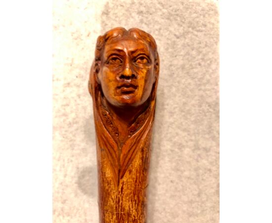 Stick in a single piece in birch wood with knob representing a female figure.     