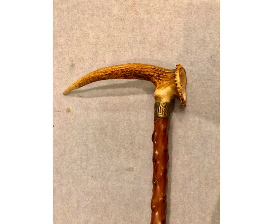 Stick with handle. Made of deer bone with a carved face.     