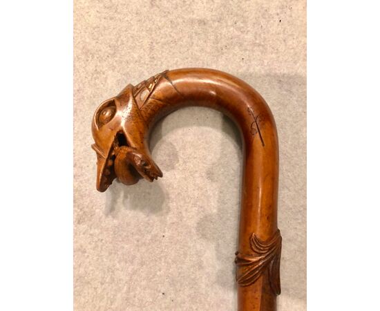 Single piece walnut stick with dragon head with lizard in its mouth.     