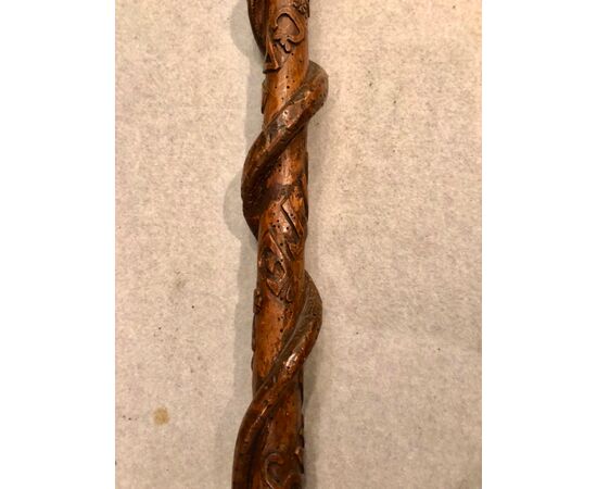 Single piece walnut stick with snake and symbols in high relief and date. France.     
