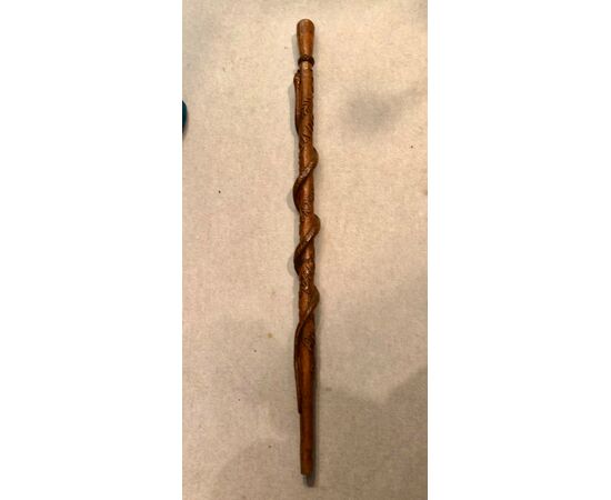 Single piece walnut stick with snake and symbols in high relief and date. France.     