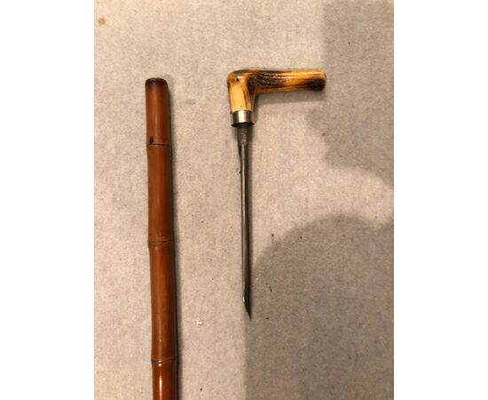 Animated stick with deer horn knob and awl to puncture grain bags. Bamboo cane.     