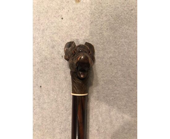 Glove stick with knob representing dog with opening mouth with button.     