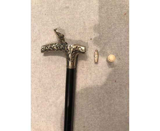 Pilgrim&#39;s staff with metal knob and inside a silver saint figure inside a bone container.     
