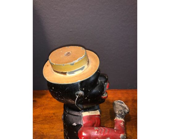 Piggy bank in antimony depicting dark brown with hat.     