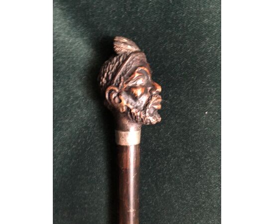 Stick with wooden knob depicting African male figure.Italy     