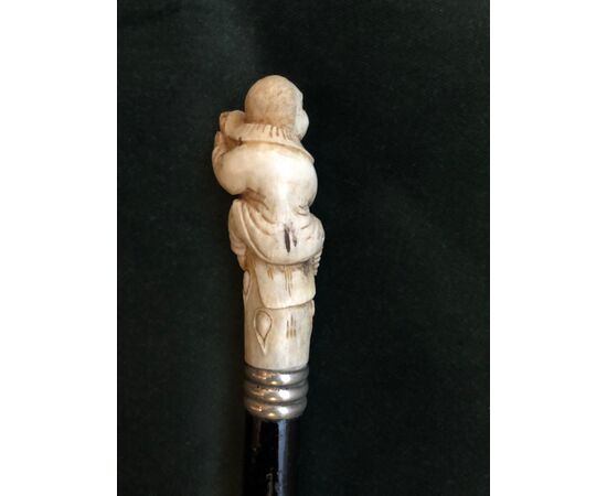 Stick with bone knob depicting a jester on a trunk Germany.     