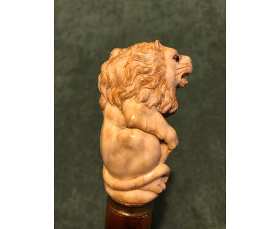 Stick with deer bone knob depicting a lion. Bamboo cane.     