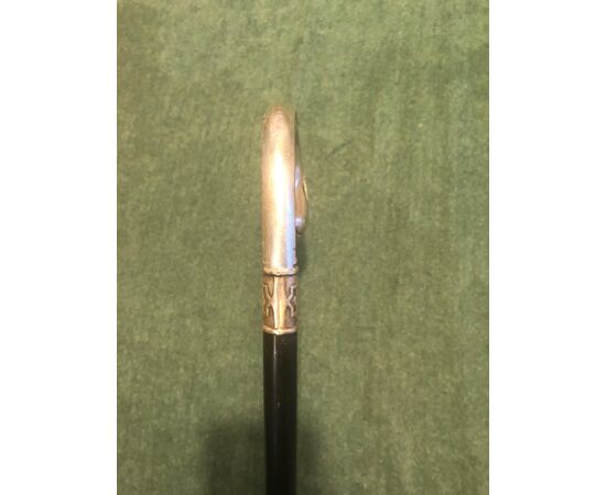 Stick with silver handle with vegetable and shell decorations. Ebony barrel.     