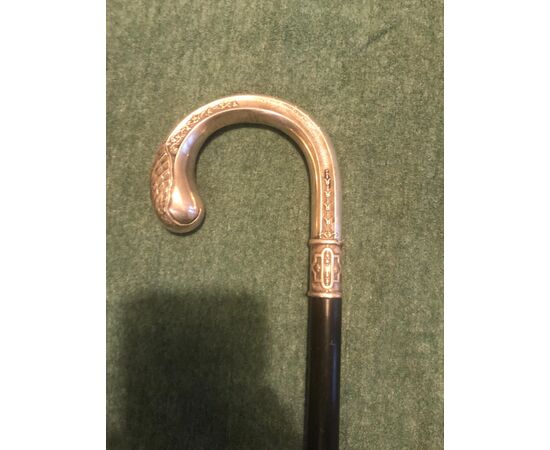 Stick with silver handle with vegetable and shell decorations. Ebony barrel.     