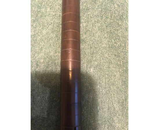 Stick with silver knob with initials, barrel with flexible core covered with wooden discs.     