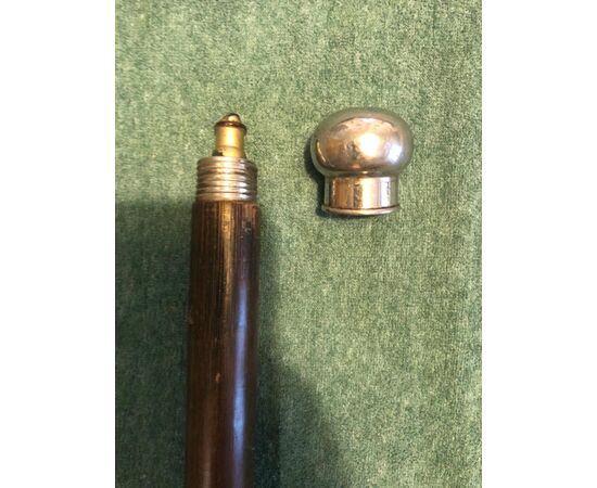 Perfume stick with metal knob and bottle inside.     
