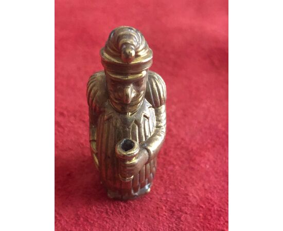Brass matchbox with a humped jester.     