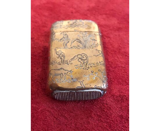 Vermeille silver matchbox without punch with oriental village scenes.     