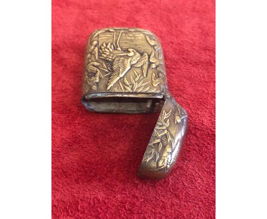 Brass matchbox with herons and birds in an art nouveau style lakeside setting.     