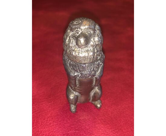 Metal matchbox in the shape of a seated dog.     