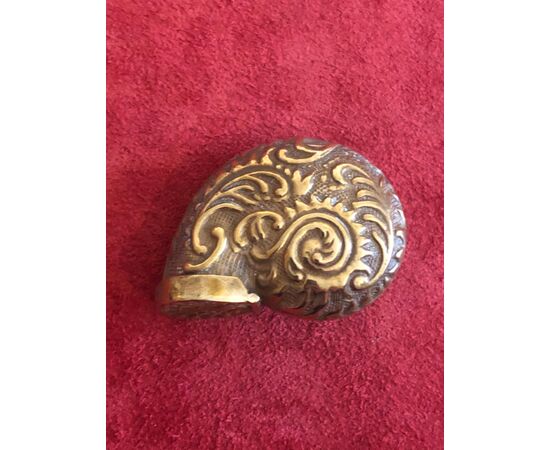 Brass matchbox in the shape of a shell with rocaille motifs.     