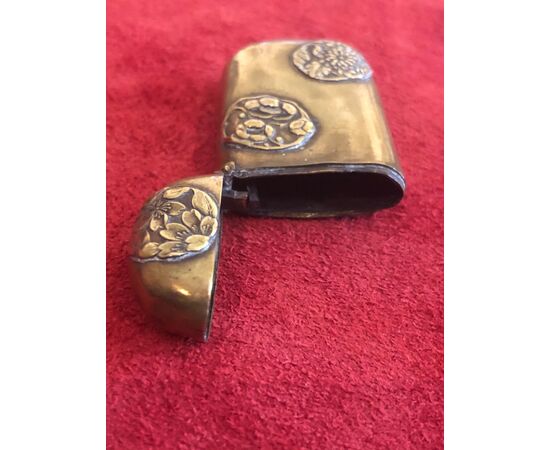 Brass matchbox with oriental floral motifs.     