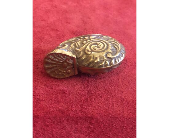 Brass matchbox in the shape of a shell with rocaille motifs.     