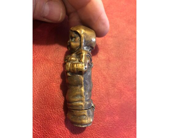 Brass matchbox in the shape of an infant child.     
