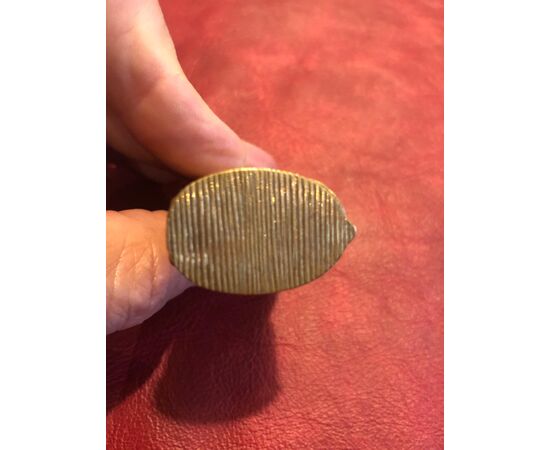 Brass matchbox in the shape of a hand with a seal.     