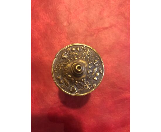 Cylindrical brass matchbox with stylized vegetable decorations.Vesta, England.     