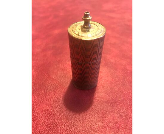 Cylindrical brass matchbox with geometric upholstery decorations.Vesta, England.     