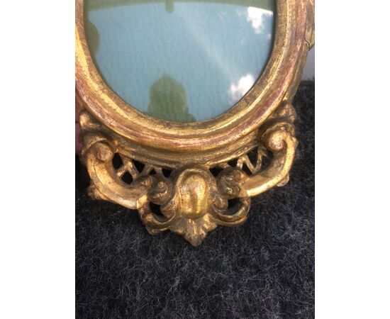 Small frame in carved and gilded wood with rocaille decoration.     