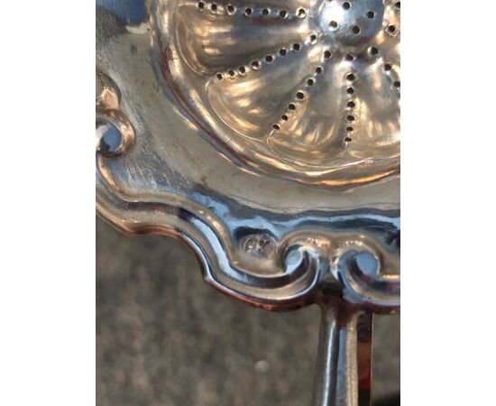 Embossed silver colander with rocaille border with three legs and ivory handle.     
