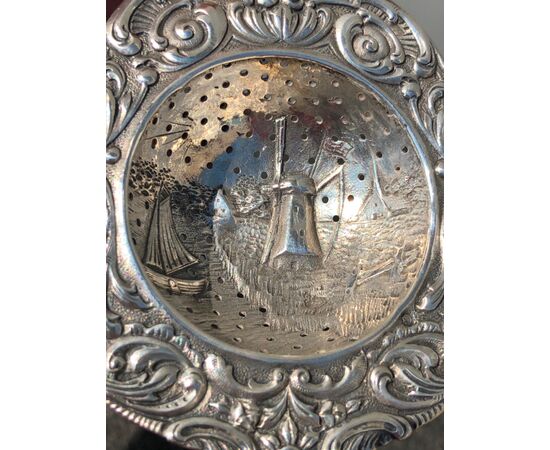 Openwork silver colander with decoration depicting mill and boat and stylized plant motifs. Holland.     