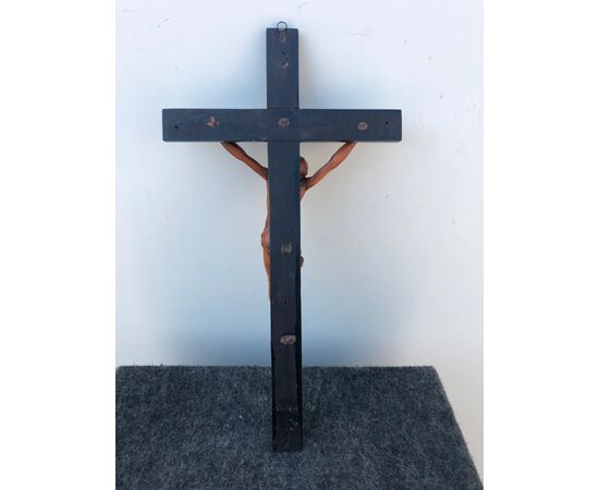 Boxwood Christ on an ebonized cross.     