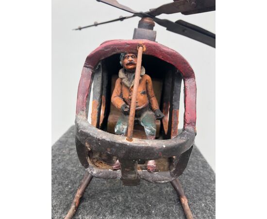 Toy model of helicopter in painted wood.     