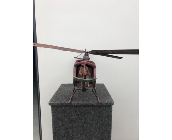 Toy model of helicopter in painted wood.     