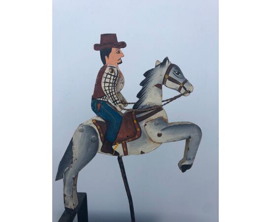 Toy model in painted iron with tilting counterweight depicting a man on horseback.     
